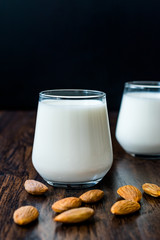 Almond Milk in Glass Cups with Almonds and Fabric Cloth.