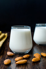 Almond Milk in Glass Cups with Almonds and Fabric Cloth.