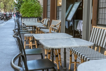 Fototapeta na wymiar Tables in a street cafe in a European city. Close-up.