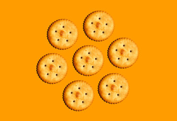 salty biscuits on orange background
