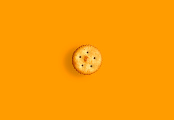 salty biscuits on orange background
