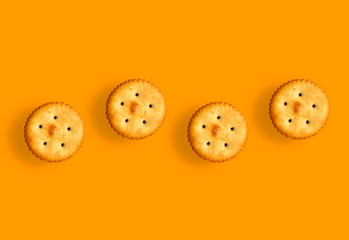 salty biscuits on orange background