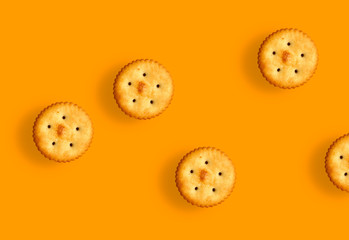 salty biscuits on orange background