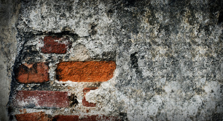 The old cement wall is broken. Old grungy brick wall with natural defects