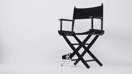 Small clapper board or movie slate with director chair use in video production or movie and cinema industry. It's put on white background.