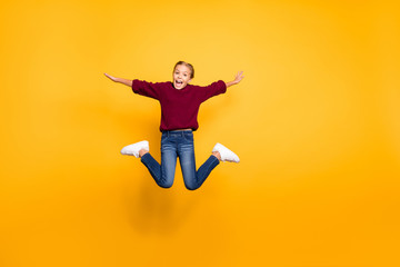 Fototapeta na wymiar Full length body size view of nice attractive carefree glad girlish cheerful cheery pre-teen girl jumping having fun flying like plane isolated on bright vivid shine vibrant yellow color background