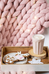 Pink pastel merino woolen giant blanket, gingerbread deer, cup with cappuccino, Christmas toy, New Year Concept, Lights 