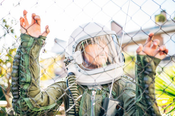 Fototapeta na wymiar Adorable kid with a astronaut uniform playing in the street