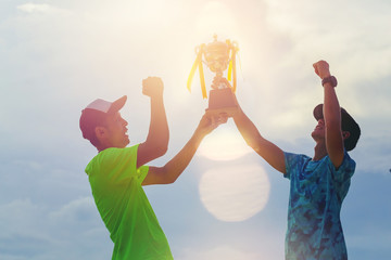 Silhouette marathon runners hand holding champion trophy award celebrate their successful. Winning teamwork finisher concept
