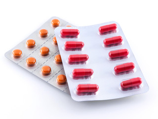Two packages of red and orange tablets on a white background