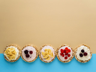 A sweet Breakfast of Crispbread, cottage cheese and fruit on a colored background. Copy space