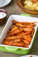 Baked carrots with dill seeds in a ceramic form