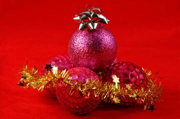 Christmas baubles with gold tinsel and a silver star on top