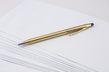 Golden and shiny pen on white envelope set