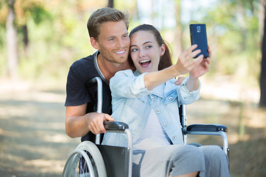 happy couple in love taking selfie in the park