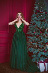 Winter holidays concept. Redhead woman in stylish look at vintage room 