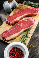 Raw ramp steak, fresh meat, marbled beef. Dark background. Flat lay
