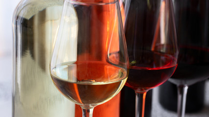 Close up of wine bottles and glasses. Beautiful abstract wine background.