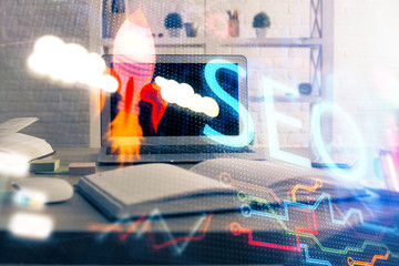Multi exposure of table with computer and seo drawing hologram. Search optimization concept.
