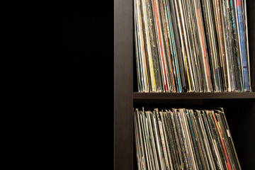 Wooden shelf full of vinyl records with copy space