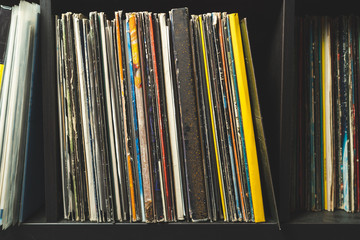 Wooden shelf full of vinyl records