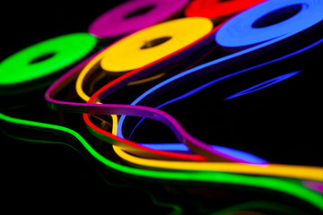 Flexible led tape neon flex in different colors on black background.