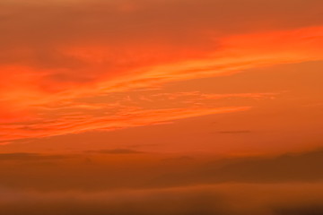 Fototapeta premium Mountain view misty morning of the mist moving on top hill above Tha Ton city with orange sun light in the sky background, sunrise at Wat Tha Ton, Chiang Mai, Thailand.