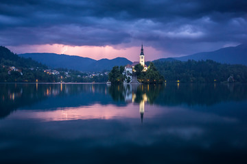 Storm clouds over a church on an island on Lake Bled, Slovenia