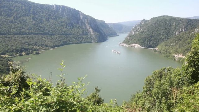  Danube river summer landscape. The cruiser ship passes through the part of the gorge on the Danube between Serbia and Romania
