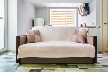 Front facing sofa with cushions in the Studio