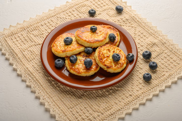 Homemade cheesecakes on a plate with berries and syrup close-up. Healthy food