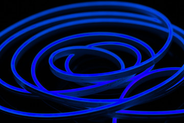 Blue flexible led tape neon flex on black background.