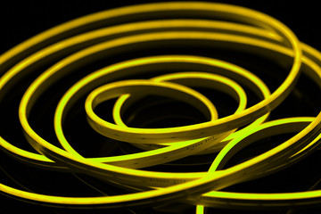 Yellow flexible led tape neon flex on black background.