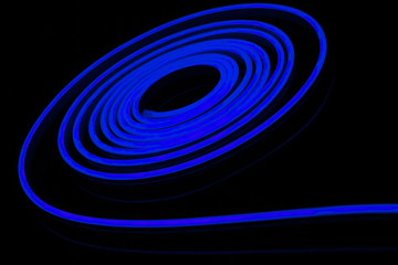 Blue flexible led tape neon flex on black background.