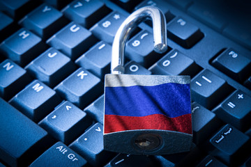 Cyber security concept open padlock on the computer keyboard with russian flag.