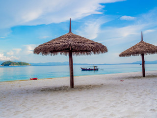 Sun shelter on white sand beach with blue sea view background, Travel plans in holidays or after retirement