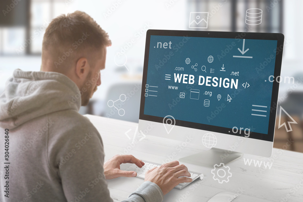 Poster Web design studio concept. Guy work on computer with Web design text surrounded by web site parts and domain extensions.