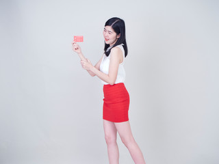 Portrait of young woman showing credit card