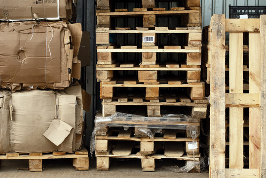 Stock Piles Of Wooden Pallets And Broken Cardboard Boxes