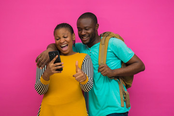 two africans got excited with what they saw on their cellphone