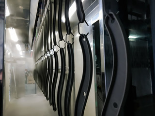 Powder coating line. Industrial interior. Workshop equipped with conveyors.
