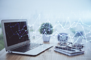 Financial chart drawing and table with computer on background. Multi exposure. Concept of international markets.