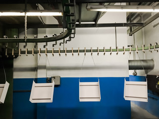Powder coating of metal parts in factory