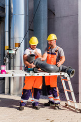 Workers assembling PVC piping