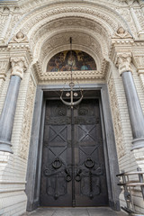 Front view of the entrance arch to the Naval Cathedral in Kronstadt with a beautiful metal door, Russia