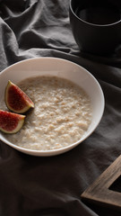 healthy oatmeal with figs on a dark background. Gluten free, lactose free,