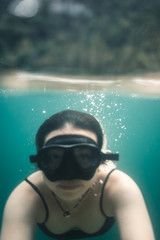 Young girl snorkeling without snorkel in blue water at the Koenigssee (Königssee) in the Berchtesgadener Land, Bavaria, Germany