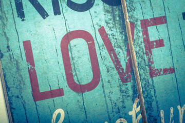 Love word printed on vintage wooden board. Calligraphy script love text.