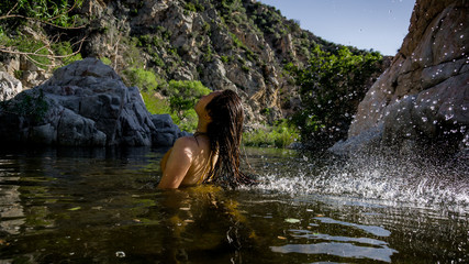 Fototapeta na wymiar Women flipping hair in Mojave river