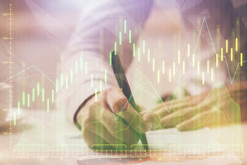 Financial trading chart multi exposure with man desktop background.